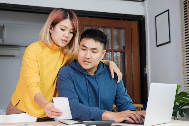 woman showing paper to man at home