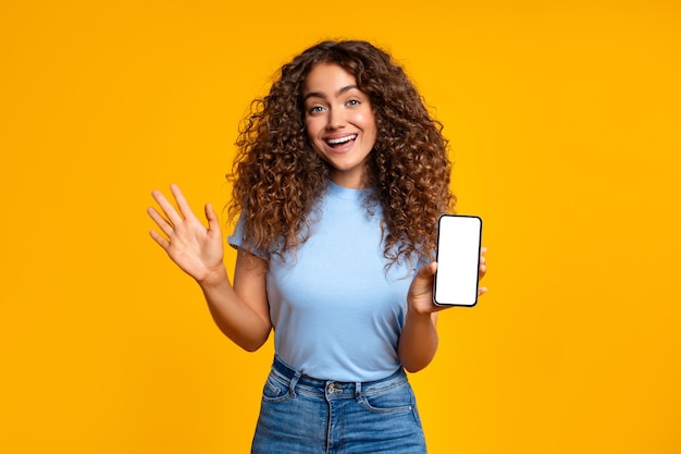 Woman showing phone screen with a happy gesture