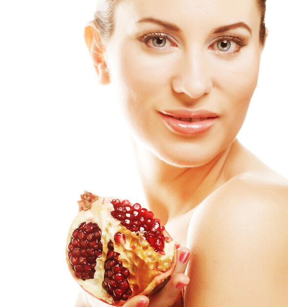 Woman showing pomegranate smiling