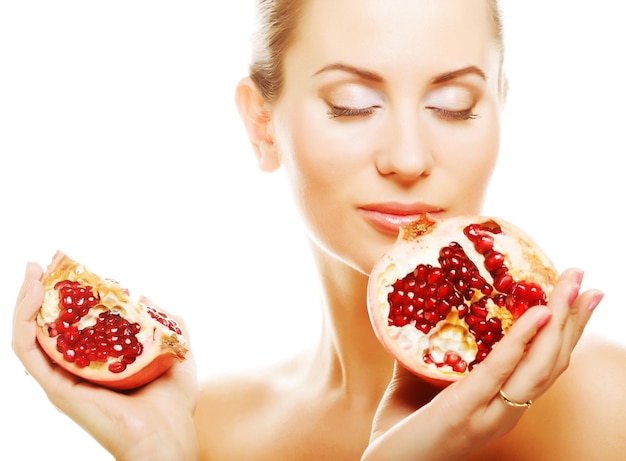 Woman showing pomegranate smiling