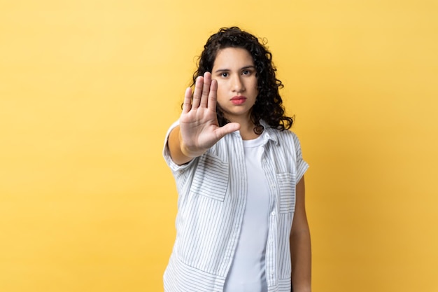 Woman showing stop gesture with palm of hand trying to stop abuser rejection domestic violence