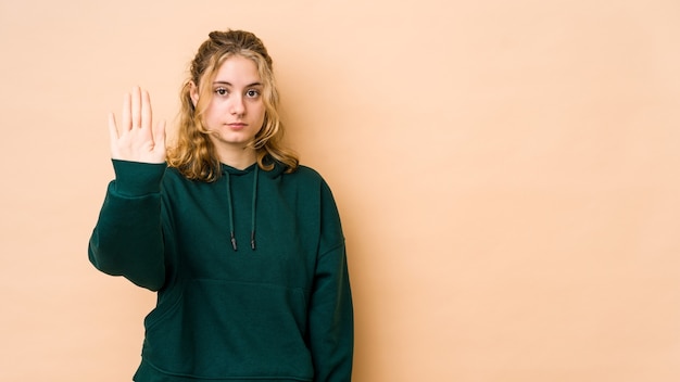 Woman showing stop sign in studio