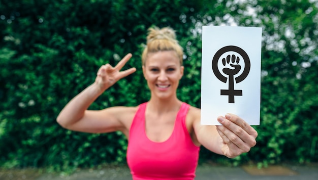 Woman showing symbol of feminism