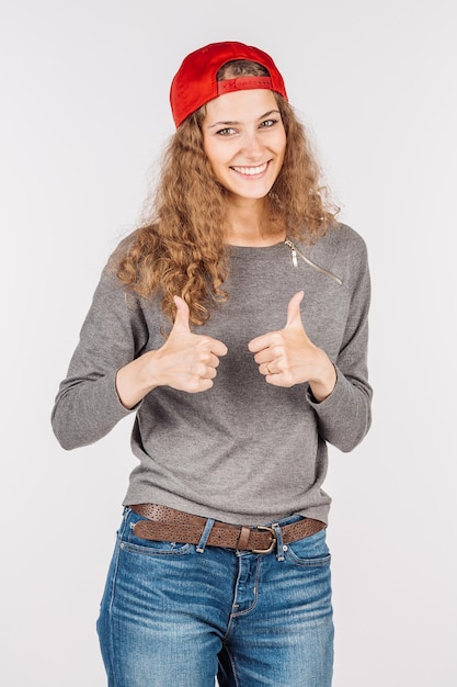 Woman showing thumbs up on a white background