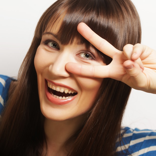 woman showing two fingers or victory gesture