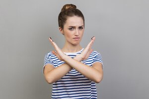 woman showing x sign with crossed hands meaning stop this is the end