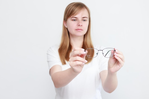 Woman shows glasses for vision vision correction poor eyesight