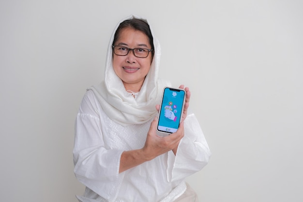 Woman shows satusehat app developed by Indonesian government to stop transmission of Coronavirus