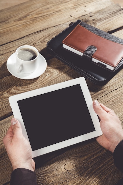 woman shows screen of digital tablet in his hands