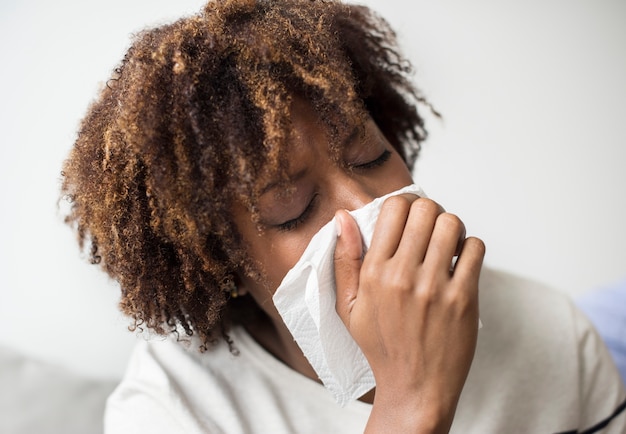 Woman sick and sneezing