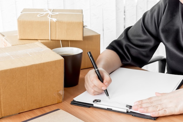 Woman signs clipboard for delivery 