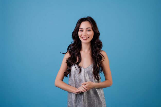 Woman in silver dress isolated over blue