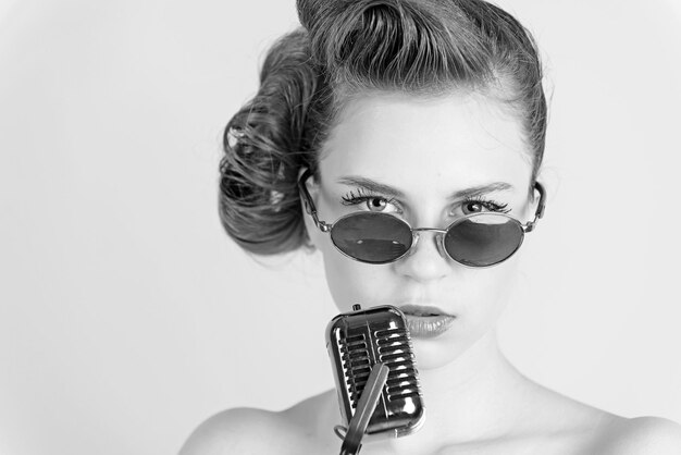 Woman singer with stylish retro hair and makeup