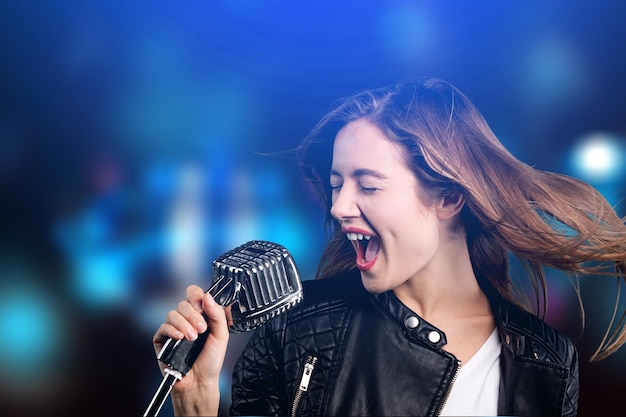 Woman singing on dark background