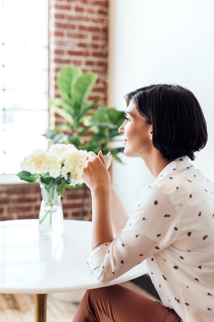 Woman sipping coffee at a cafe