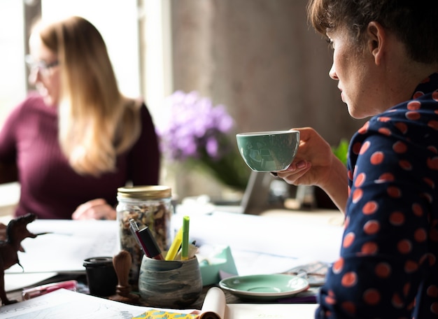 Woman Sipping Coffee from Cup on Office