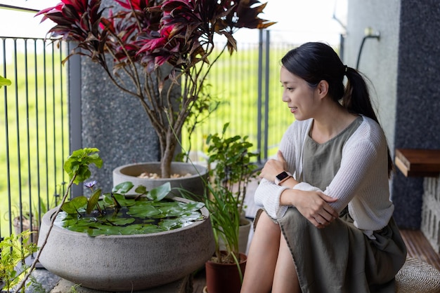 Woman sit at balcony and look outside