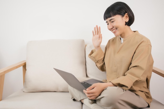 Woman sit on couch and make video call with her friends