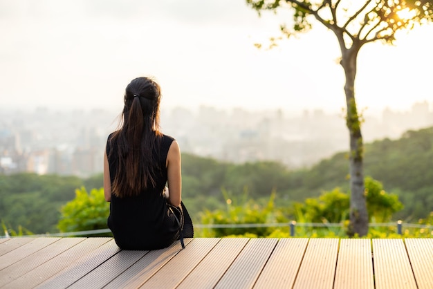 Woman sit and look at the sunset view