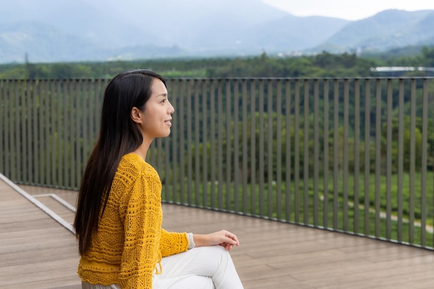 Woman sit at outdoor and enjoy the scenery view