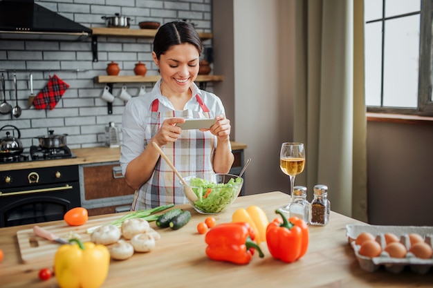 Woman sit at table in kitchen