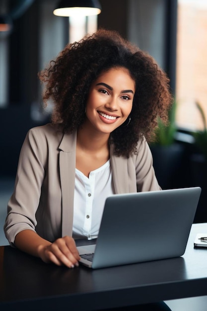 a woman sits at a desk with a laptop and a coffee cup behind her