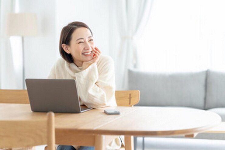 Photo 女性がラップトップとマウスでテーブルに座っている