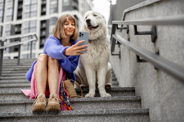 Woman sits with her dog at modern residential area