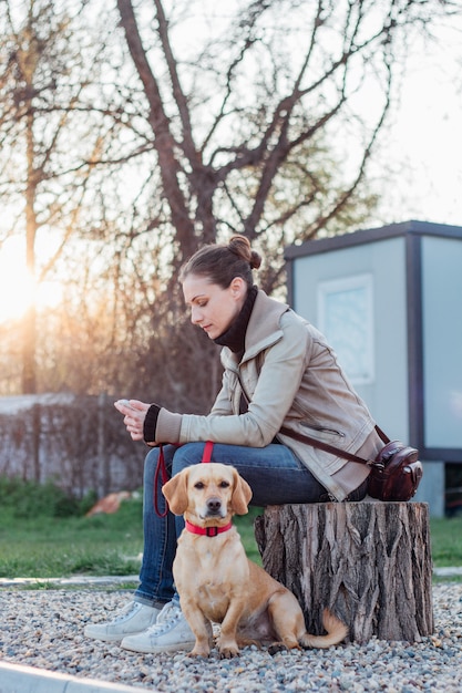 Woman sitting in backyard with her dog