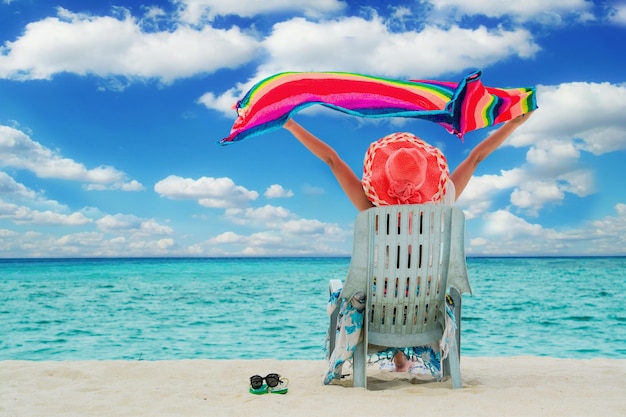 Woman sitting on the beach chair