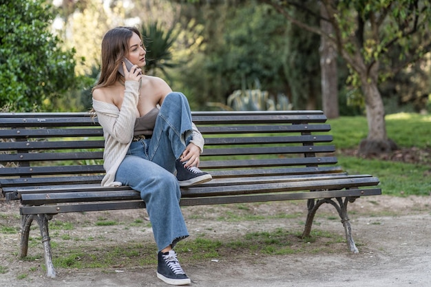 Woman sitting on bench in park