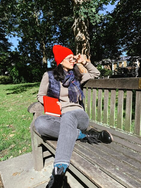 Woman sitting on bench in park