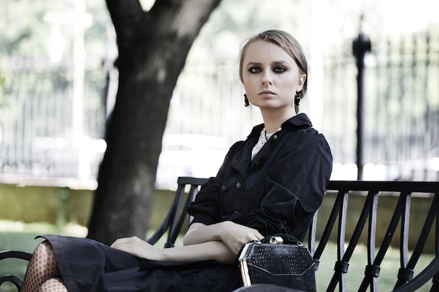 Woman sitting on a bench in park