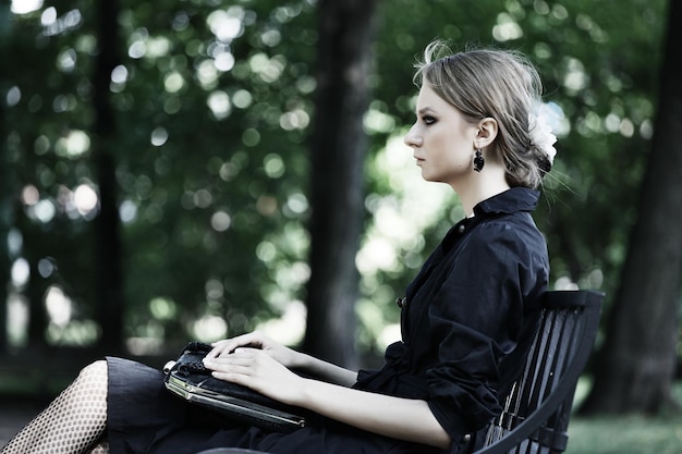 Woman sitting on a bench in park