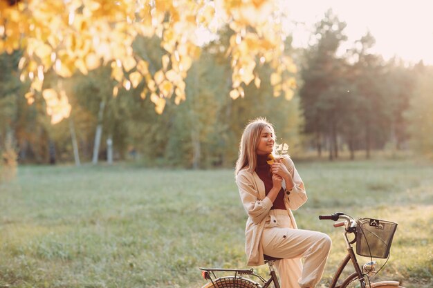 Woman sitting on bicycle in park