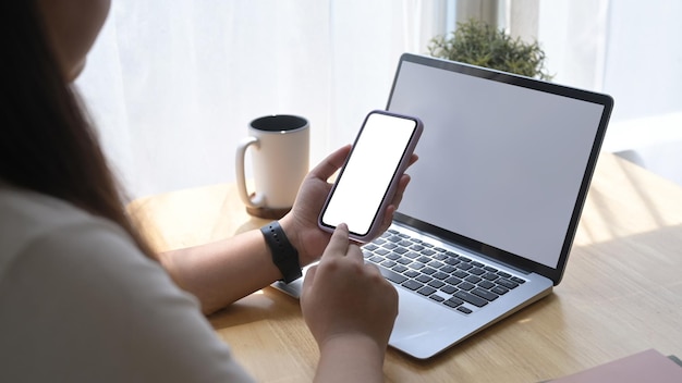 Woman sitting in bright living room and using mobile phone checking social media