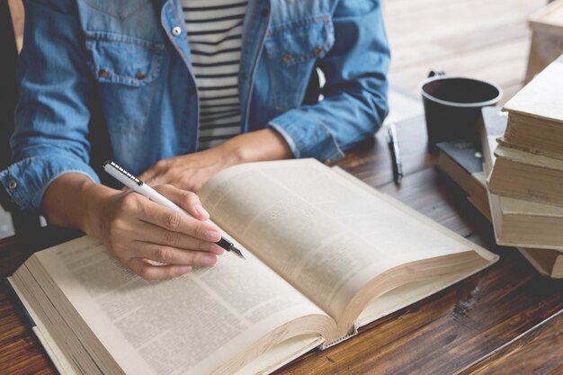 Woman sitting in a cafe, reading book