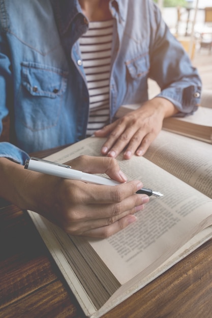 Woman sitting in a cafe, reading book