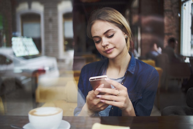 woman sitting at a cafe table having a snack in the morning lifestyle leisure socializing