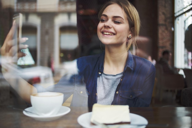 woman sitting at a cafe table having a snack in the morning lifestyle leisure socializing