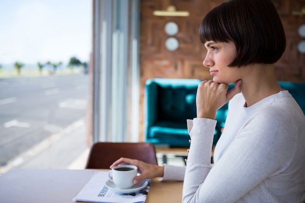 Woman sitting in cafeteria