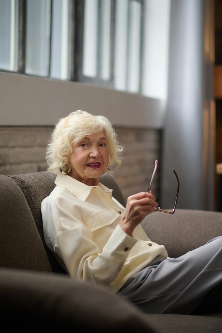 Woman sitting on couch sideways to camera