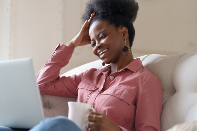 woman sitting on couch talking on video chat