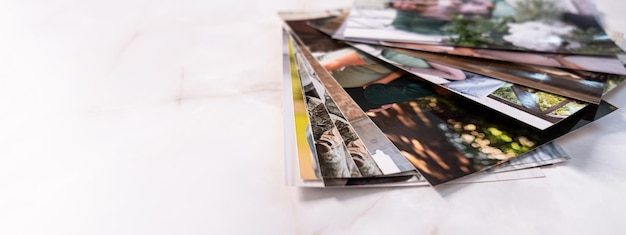 Woman sitting at desk and looking at printed photos remember nostalgia for a day of rest photography cards background Mock up