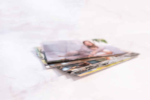 Woman sitting at desk and looking at printed photos remember nostalgia for a day of rest photography cards background Mock up