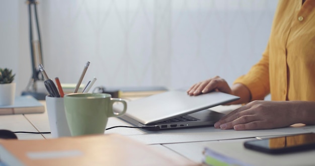 Woman sitting at desk and using her laptop