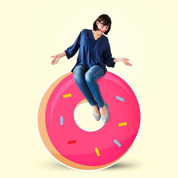 Photo woman sitting on a doughnut