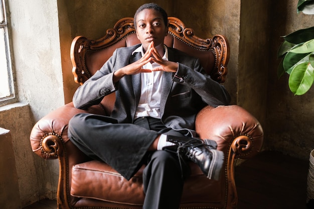 Woman sitting on elegant sofa representing female empowerment