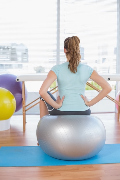 Woman sitting on exercise ball 