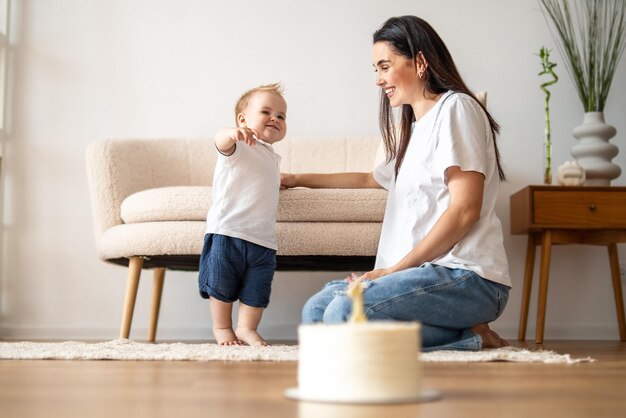 Woman Sitting on Floor Next to Baby